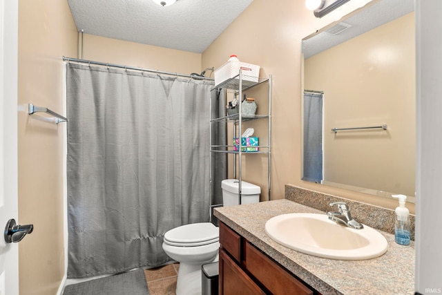 bathroom with a shower with shower curtain, toilet, a textured ceiling, vanity, and tile patterned flooring