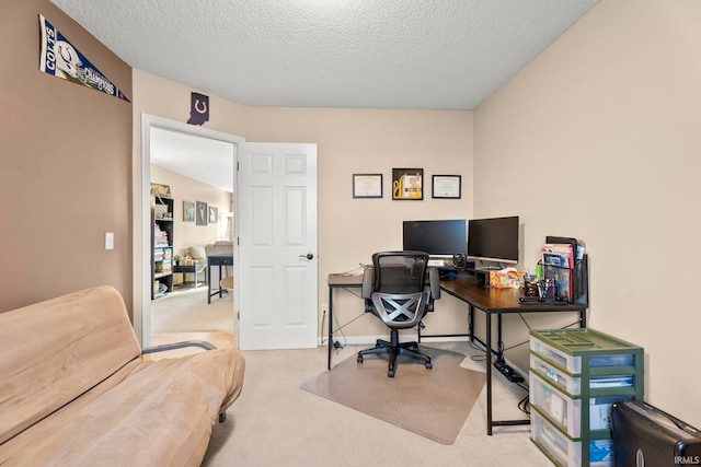 carpeted home office with a textured ceiling