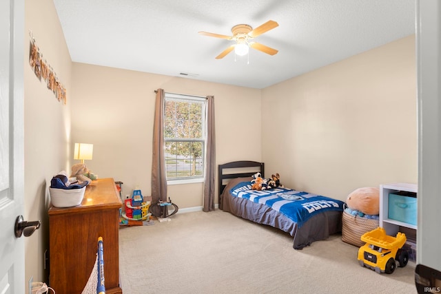 bedroom featuring visible vents, baseboards, ceiling fan, a textured ceiling, and carpet floors