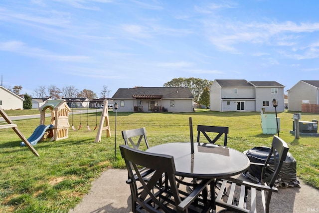 view of patio with a residential view, a playground, and outdoor dining space