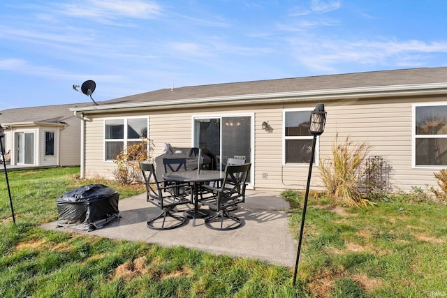 rear view of house featuring a lawn and a patio