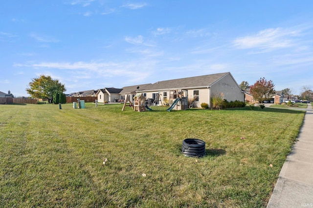 view of front of home featuring a front yard and a playground