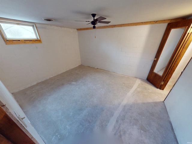 interior space featuring concrete flooring, concrete block wall, and visible vents