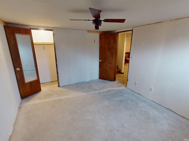 unfurnished bedroom with a ceiling fan and concrete floors