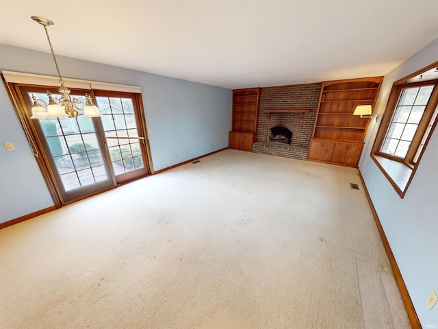 unfurnished living room with carpet floors, a brick fireplace, baseboards, and visible vents