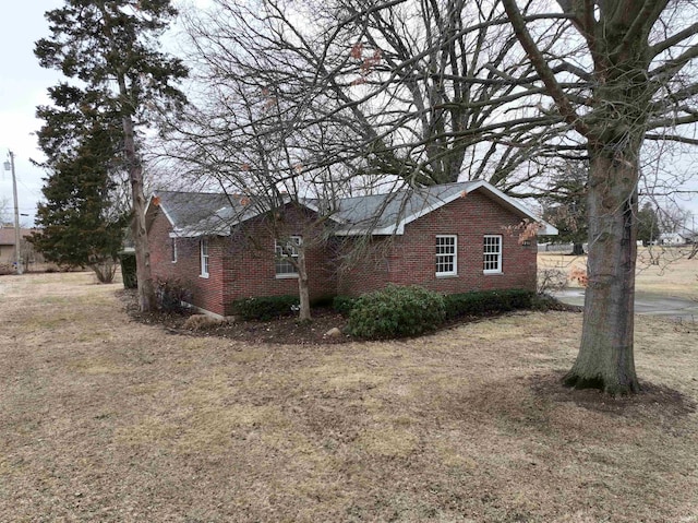 view of side of property featuring brick siding