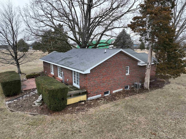 view of property exterior with brick siding and central AC unit