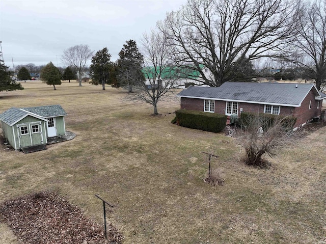 view of yard with an outbuilding and a shed