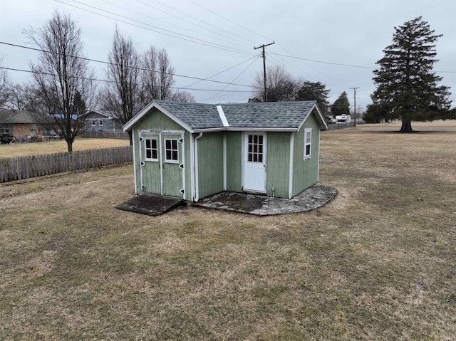 view of shed featuring fence