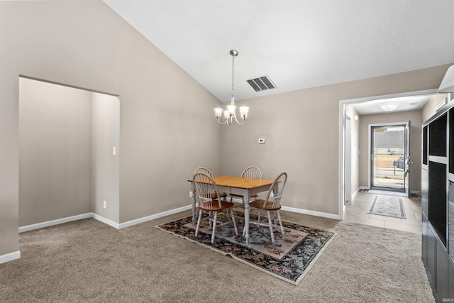 carpeted dining room featuring lofted ceiling, visible vents, a chandelier, baseboards, and tile patterned floors