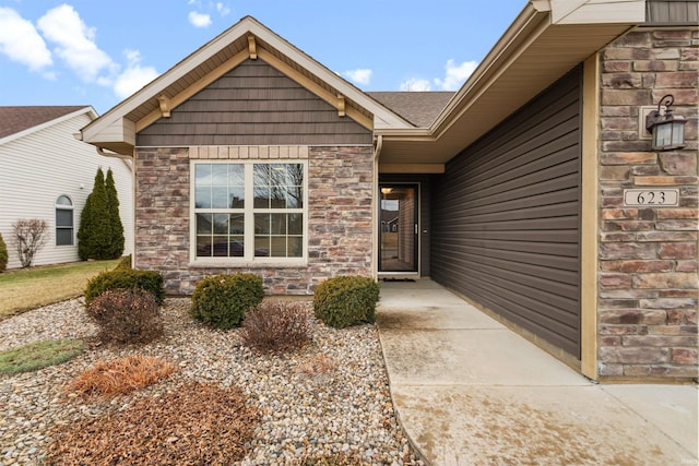 property entrance with stone siding