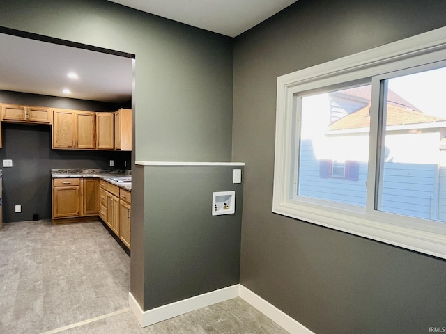 kitchen featuring dark countertops, recessed lighting, and baseboards