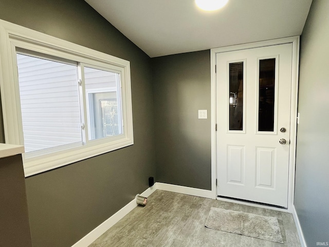 interior space with baseboards and wood finished floors