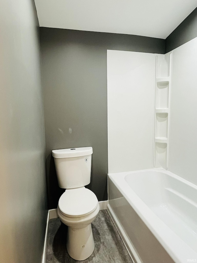 full bath featuring toilet and baseboards