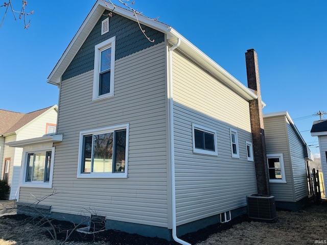 rear view of property featuring central air condition unit