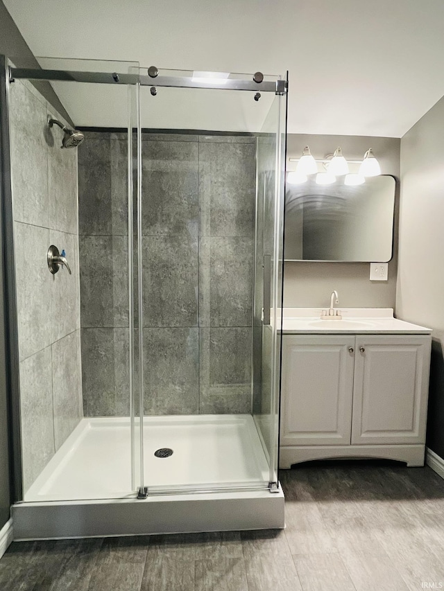 bathroom featuring a shower stall and vanity