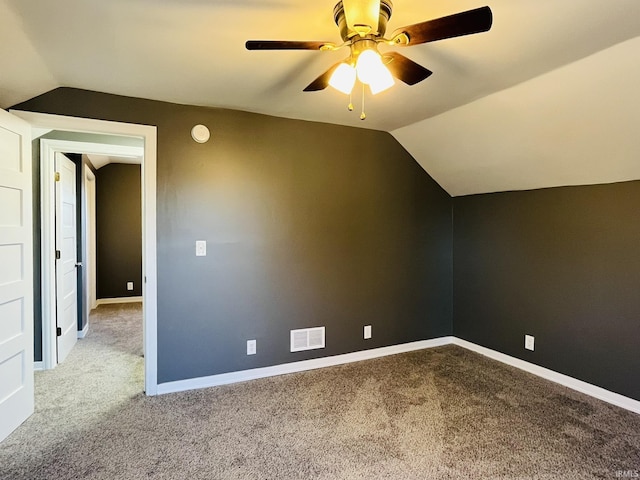 bonus room with carpet, visible vents, and vaulted ceiling