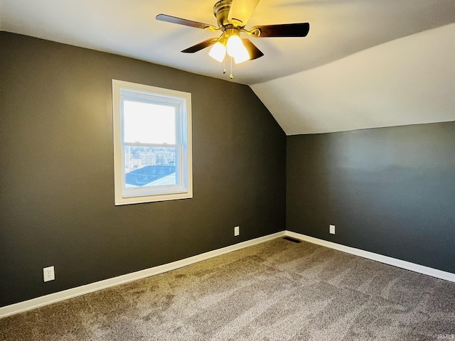 additional living space featuring a ceiling fan, carpet, lofted ceiling, and baseboards