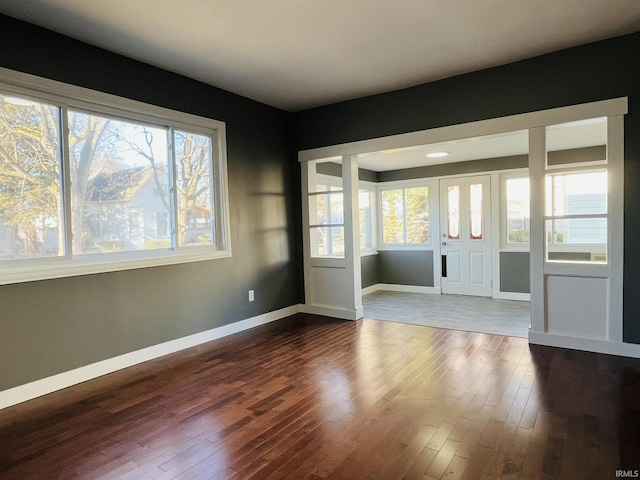 entrance foyer featuring dark wood-style floors and baseboards