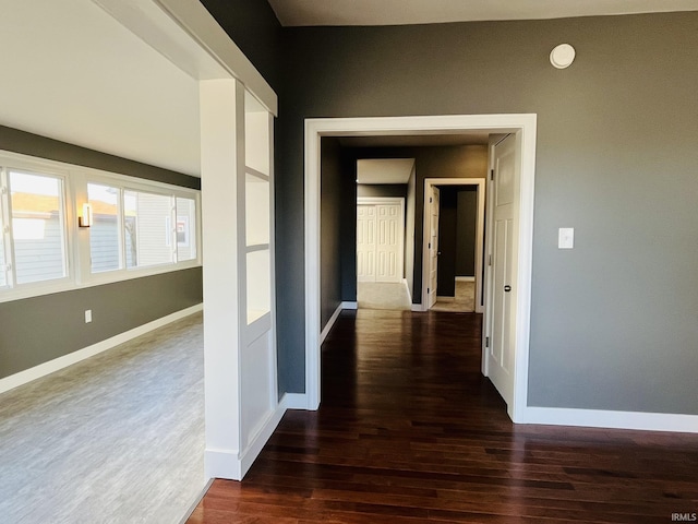 hall featuring wood finished floors and baseboards