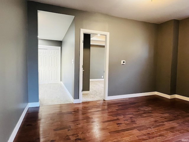 empty room featuring baseboards and wood finished floors