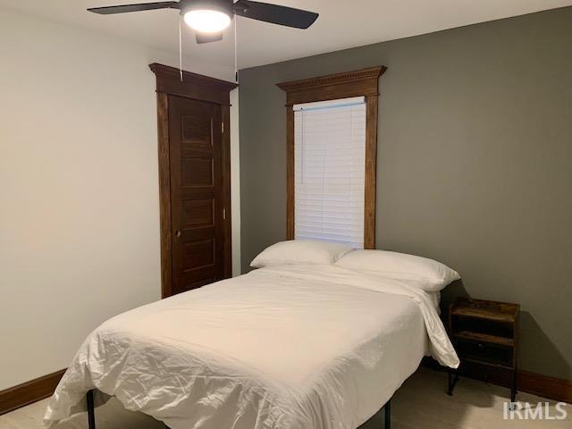 bedroom with baseboards and ceiling fan