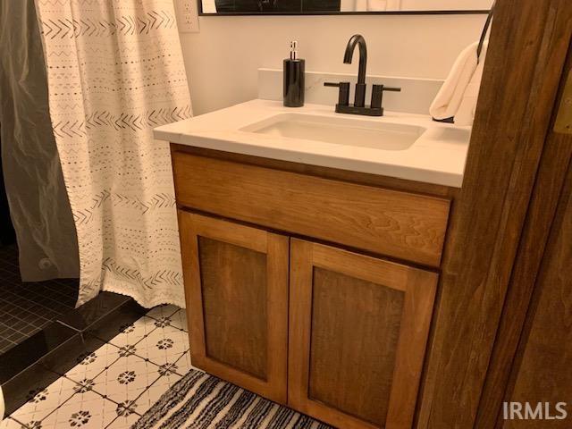 full bathroom featuring vanity and curtained shower