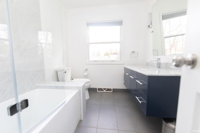 full bathroom featuring a bathtub, visible vents, toilet, baseboards, and tile patterned floors