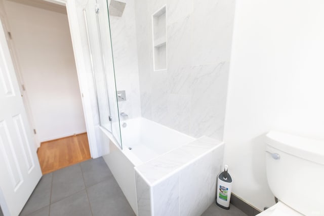 bathroom with toilet, bathtub / shower combination, and tile patterned floors