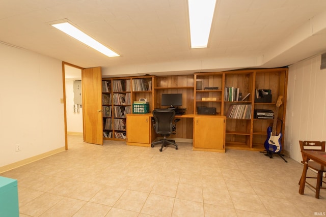 office area with wood walls