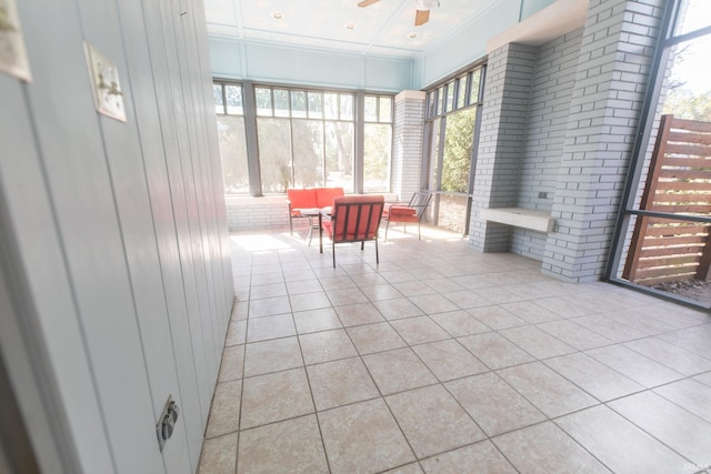 unfurnished sunroom with ceiling fan