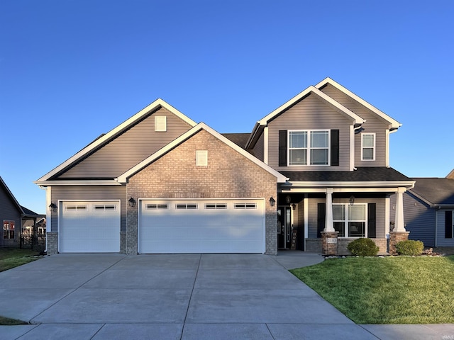 craftsman house featuring brick siding, a porch, concrete driveway, a garage, and a front lawn