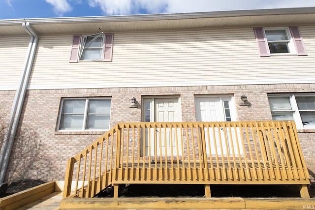 rear view of property featuring brick siding