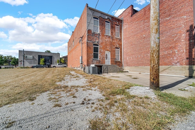 exterior space with brick siding and central air condition unit