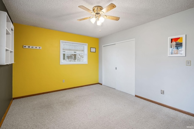 unfurnished bedroom featuring carpet floors, baseboards, and a textured ceiling