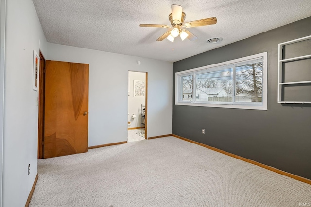 unfurnished bedroom featuring visible vents, baseboards, ceiling fan, carpet, and a textured ceiling