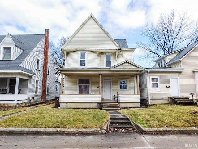 view of front of property featuring covered porch and a front yard