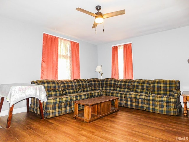 living area with ceiling fan and wood finished floors