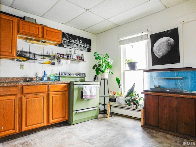 kitchen featuring white electric stove, a baseboard radiator, a paneled ceiling, brown cabinetry, and dark countertops