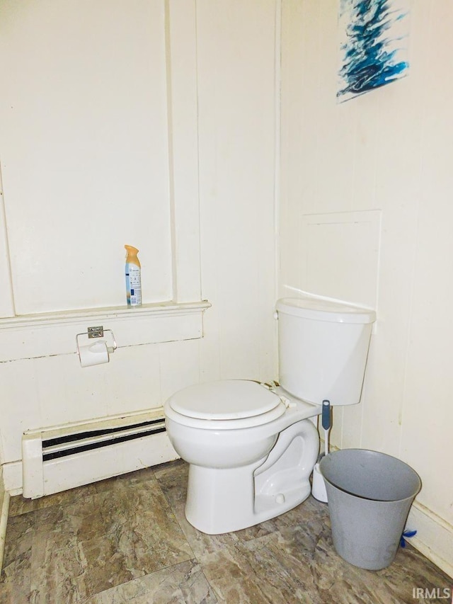 bathroom with a baseboard heating unit and toilet