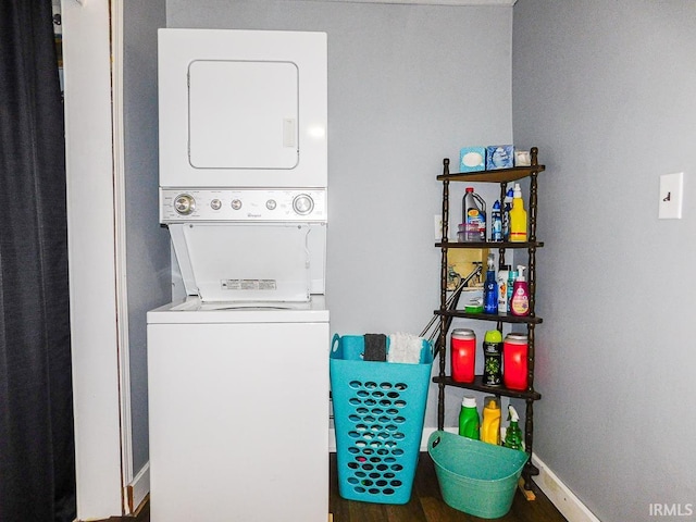 laundry area featuring stacked washer and dryer, laundry area, and baseboards