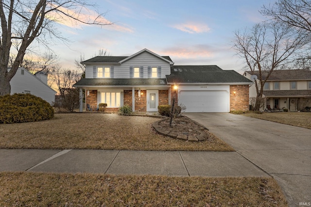 traditional-style house with a lawn, concrete driveway, an attached garage, covered porch, and brick siding