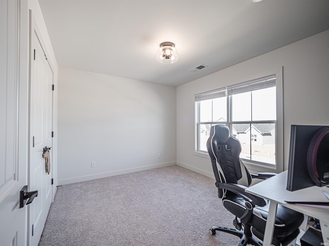 carpeted office with baseboards and visible vents