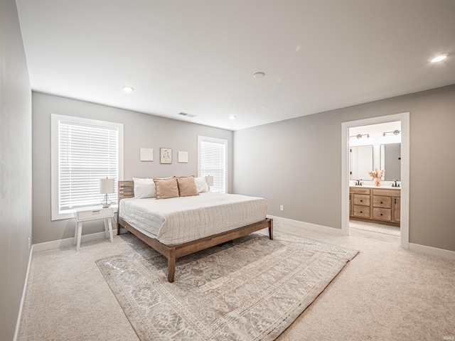 bedroom with light carpet, recessed lighting, visible vents, and baseboards