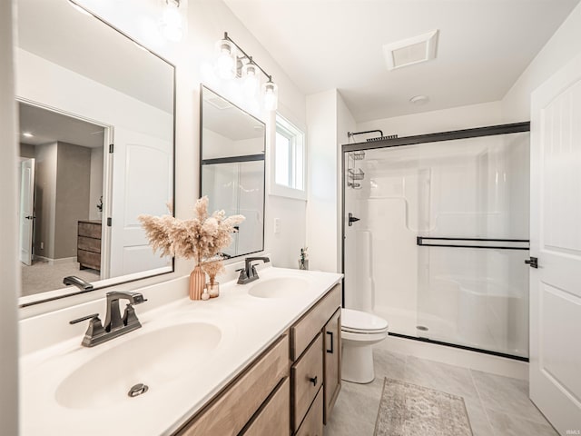 full bath featuring double vanity, a stall shower, and a sink