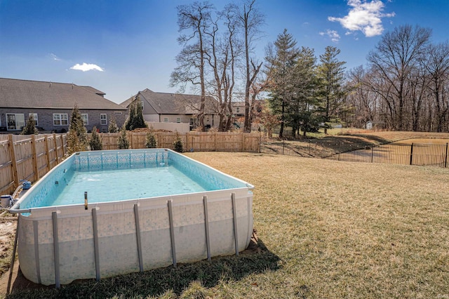 view of pool featuring a fenced backyard, a fenced in pool, and a lawn