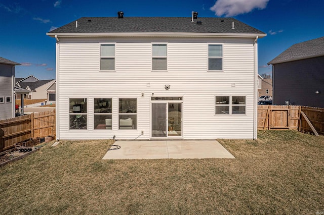 rear view of house featuring a lawn, a patio area, and a fenced backyard