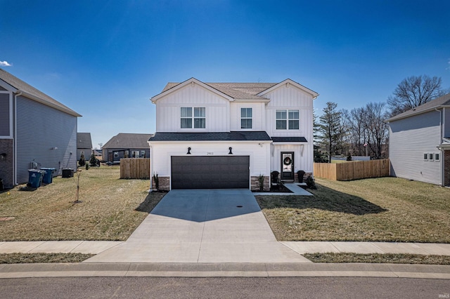 modern farmhouse featuring board and batten siding, a front yard, fence, a garage, and driveway