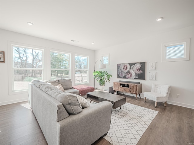 living room with recessed lighting, wood finished floors, visible vents, and baseboards