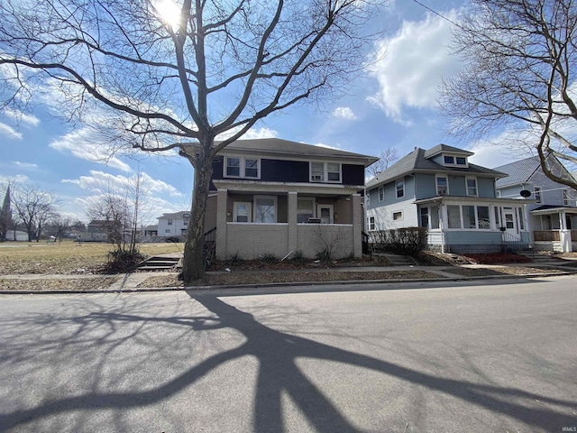 american foursquare style home with brick siding